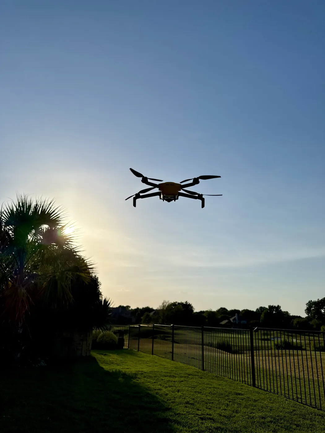 Our drone in flight over a backyard at sunset
